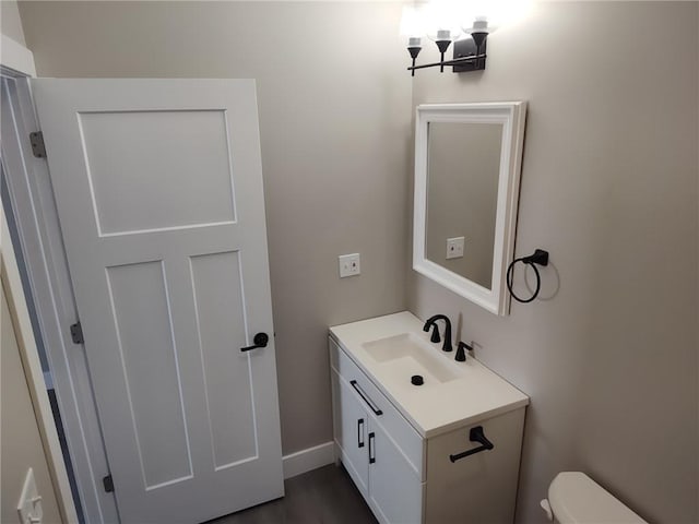 bathroom featuring toilet and vanity