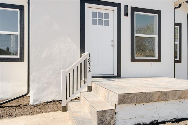 doorway to property with stucco siding