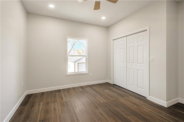 unfurnished bedroom featuring dark wood finished floors, recessed lighting, baseboards, and a closet