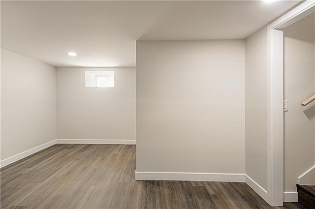 unfurnished room featuring stairway, wood finished floors, and baseboards