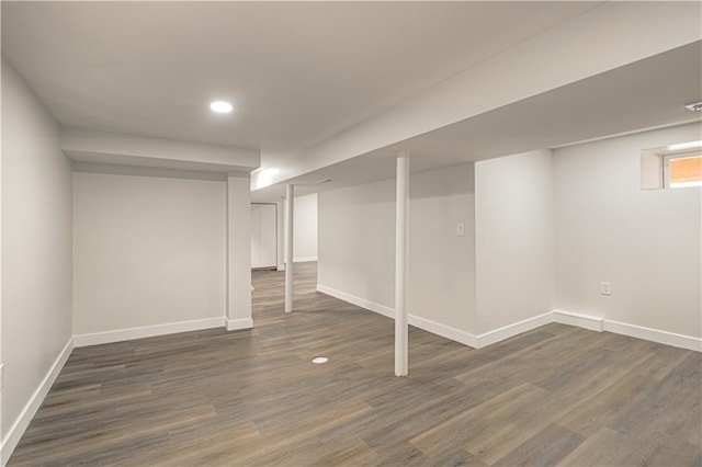 basement featuring recessed lighting, baseboards, and dark wood-style flooring