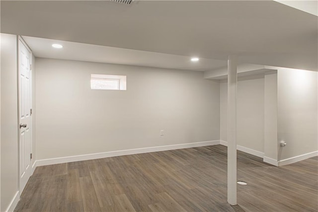 basement with recessed lighting, wood finished floors, and baseboards