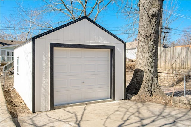 detached garage featuring fence