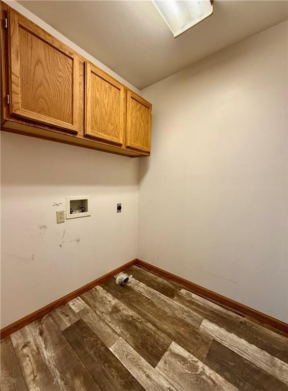 clothes washing area featuring baseboards, cabinet space, electric dryer hookup, washer hookup, and hardwood / wood-style flooring