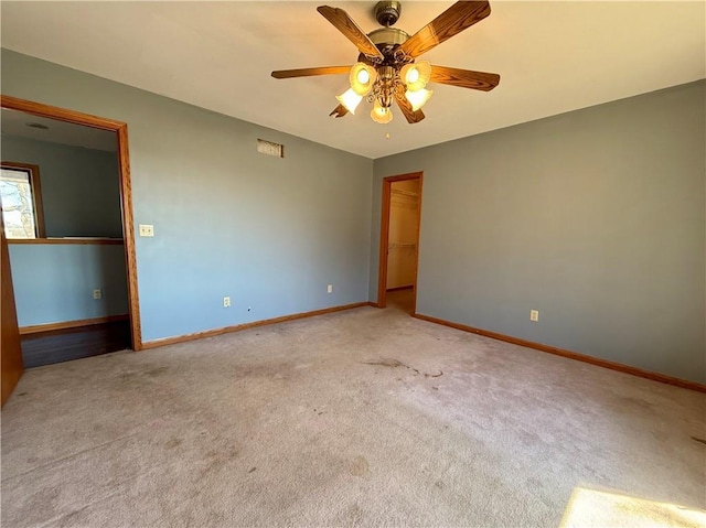 unfurnished bedroom with carpet flooring, baseboards, a closet, and ceiling fan