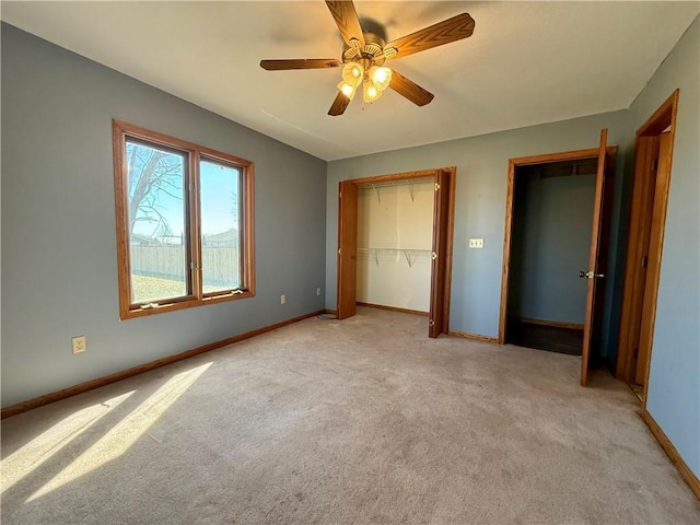 unfurnished bedroom featuring baseboards, light carpet, and ceiling fan