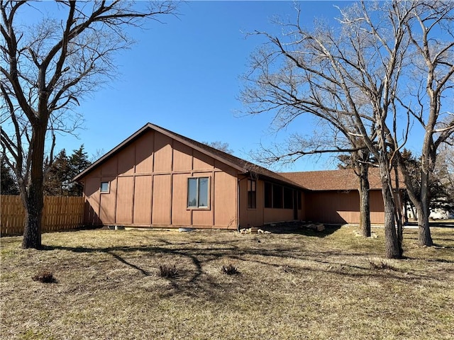 view of home's exterior with an attached garage and fence