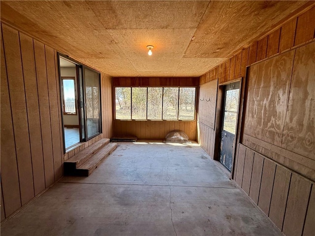 unfurnished sunroom with wooden ceiling