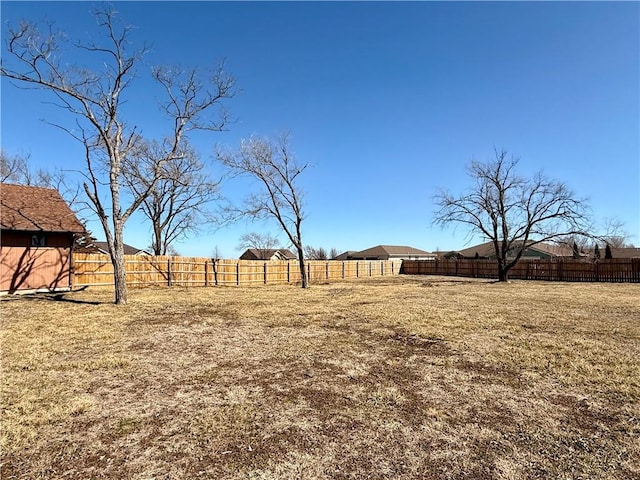 view of yard with a rural view and a fenced backyard