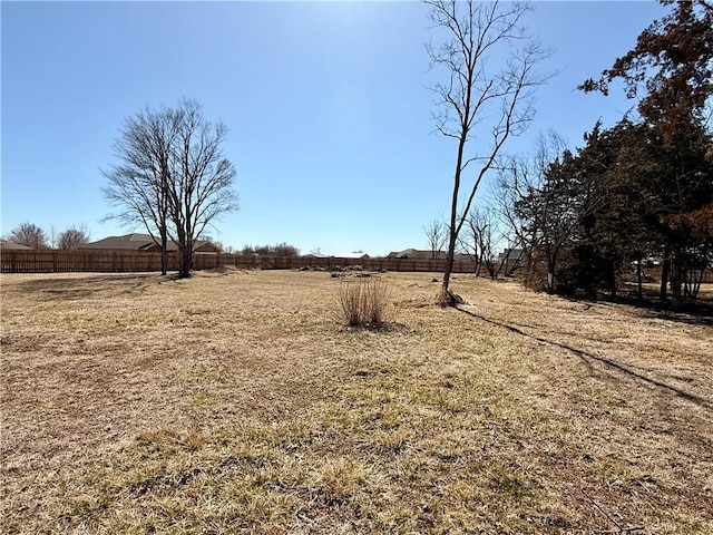 view of yard featuring a rural view and fence