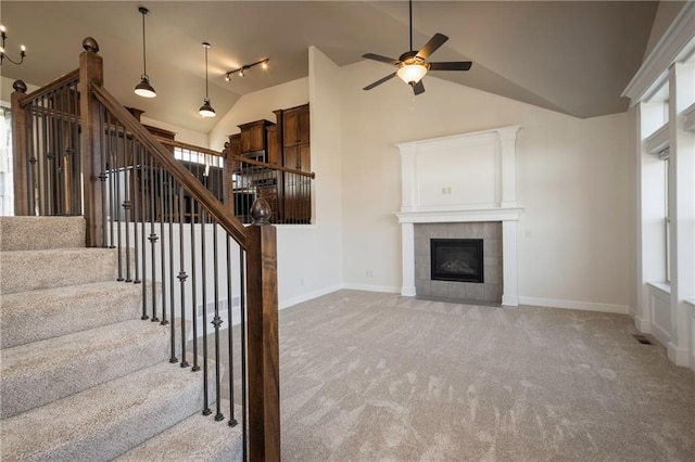 unfurnished living room featuring stairs, a fireplace, baseboards, and light carpet