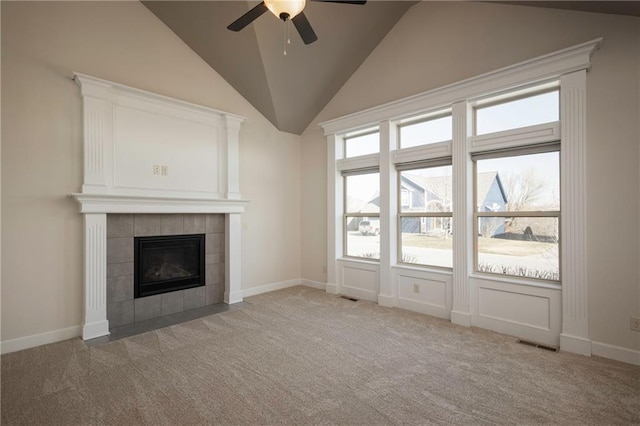 unfurnished living room with carpet, baseboards, visible vents, lofted ceiling, and a tile fireplace