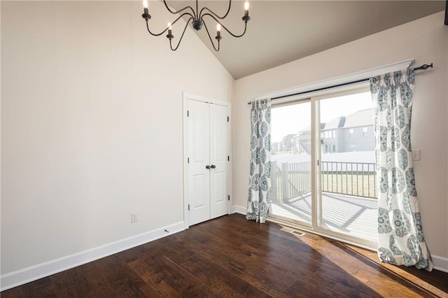 unfurnished dining area with visible vents, baseboards, an inviting chandelier, dark wood-type flooring, and vaulted ceiling