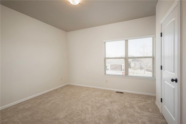 unfurnished room featuring carpet flooring, baseboards, and visible vents