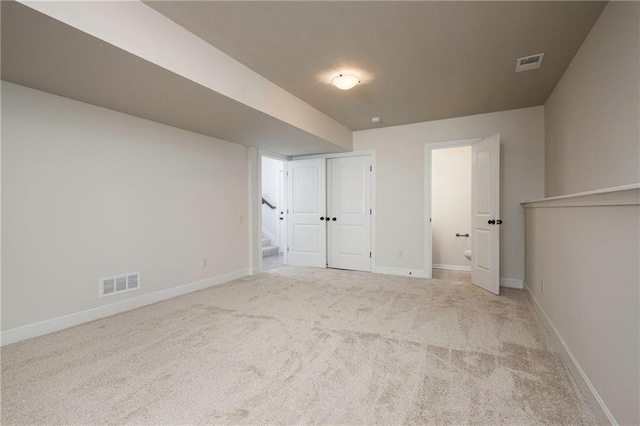 interior space featuring visible vents, carpet floors, baseboards, and stairs