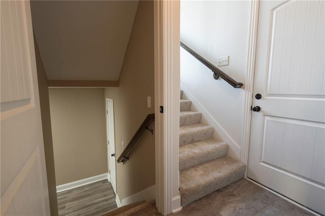 staircase featuring baseboards