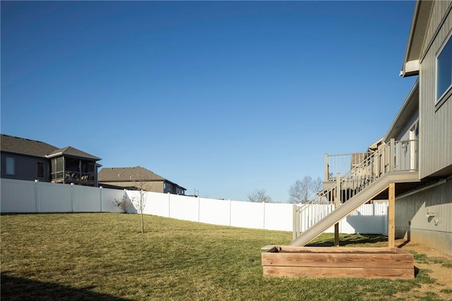 view of yard featuring stairs and a fenced backyard