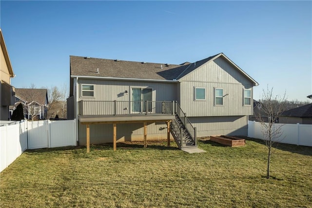 rear view of house featuring a yard, a wooden deck, stairs, and a fenced backyard