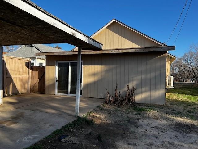 view of side of property featuring a patio area and fence