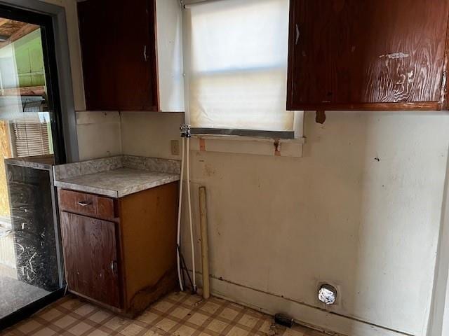 kitchen featuring beverage cooler, light floors, and light countertops