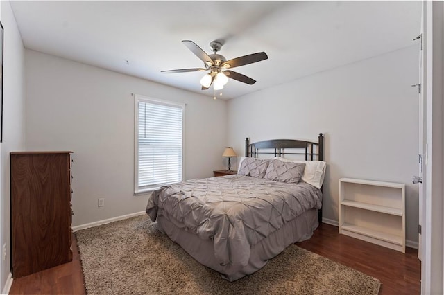 bedroom featuring a ceiling fan, baseboards, and wood finished floors