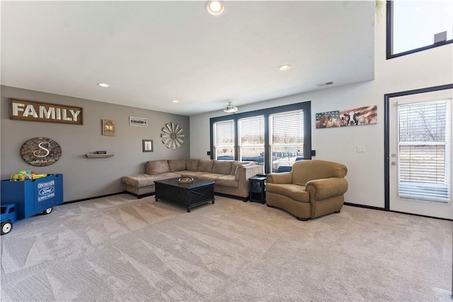 carpeted living area with plenty of natural light, recessed lighting, and visible vents