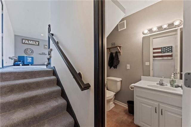 staircase featuring tile patterned flooring, baseboards, and visible vents