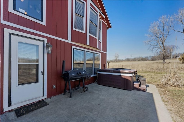 exterior space featuring area for grilling and a hot tub