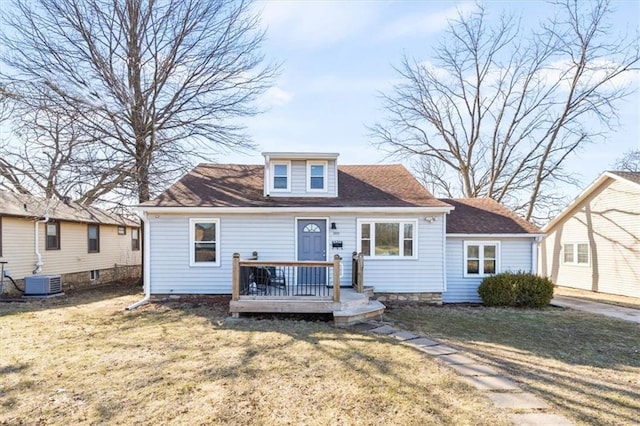 view of front of property with a wooden deck, central AC, and a front lawn