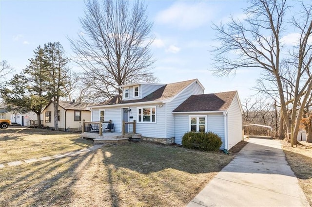 bungalow-style house with a deck, driveway, and a front lawn