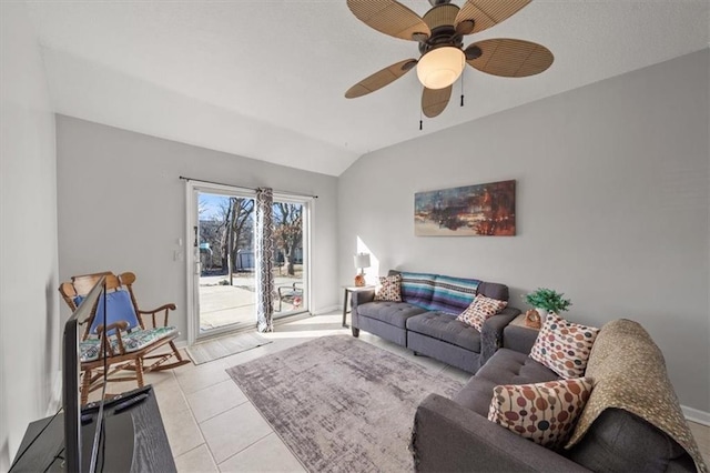 living area featuring light tile patterned floors, lofted ceiling, and a ceiling fan