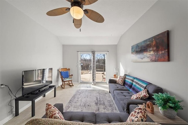 tiled living room with baseboards, ceiling fan, and vaulted ceiling