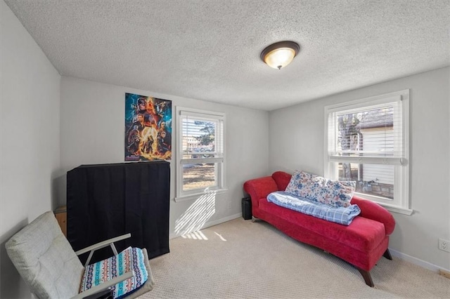 carpeted bedroom featuring baseboards and a textured ceiling