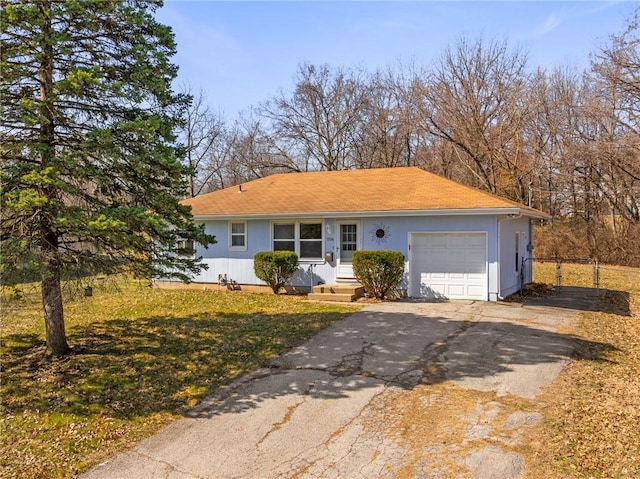 ranch-style house with aphalt driveway and an attached garage