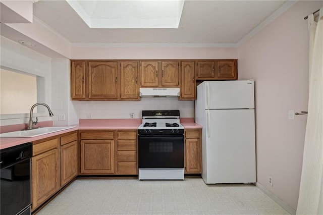 kitchen featuring under cabinet range hood, a sink, range with gas stovetop, black dishwasher, and freestanding refrigerator