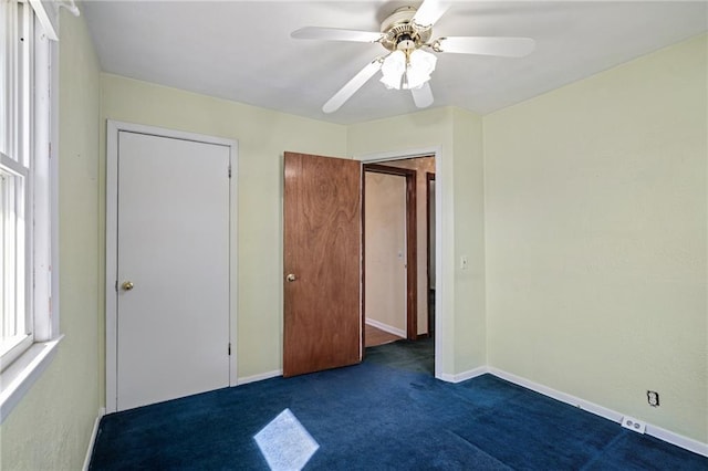 unfurnished bedroom featuring ceiling fan, baseboards, and carpet