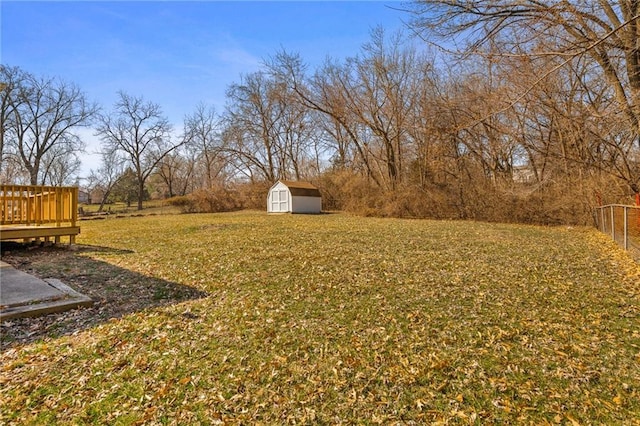 view of yard with a storage unit, a deck, and an outdoor structure