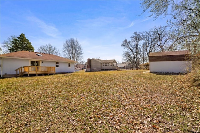 view of yard featuring an outbuilding and a wooden deck