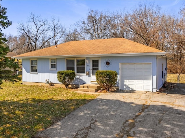 ranch-style home with aphalt driveway, fence, a front yard, a shingled roof, and a garage