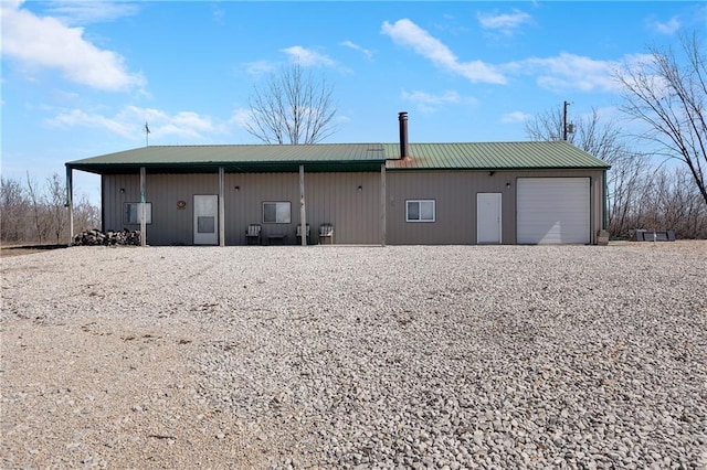 rear view of property featuring metal roof