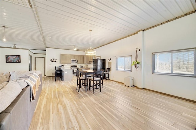 dining room featuring baseboards and light wood finished floors