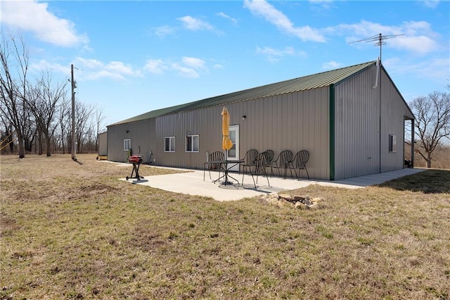 rear view of house with a yard and a patio area