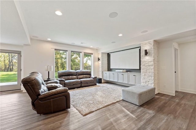 living room featuring recessed lighting, baseboards, and wood finished floors