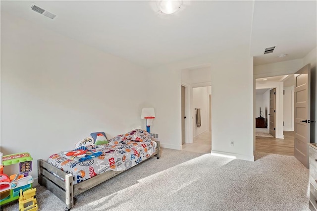 bedroom with visible vents, baseboards, and carpet