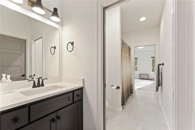 bathroom featuring tile patterned flooring, baseboards, toilet, recessed lighting, and vanity