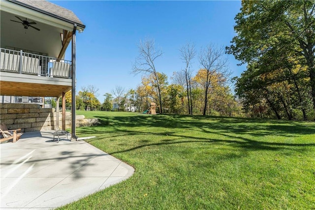 view of yard with a patio, ceiling fan, and a playground