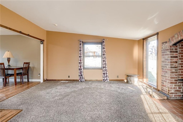 living room featuring carpet and baseboards