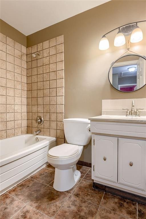 full bathroom featuring baseboards, vanity, toilet, and washtub / shower combination