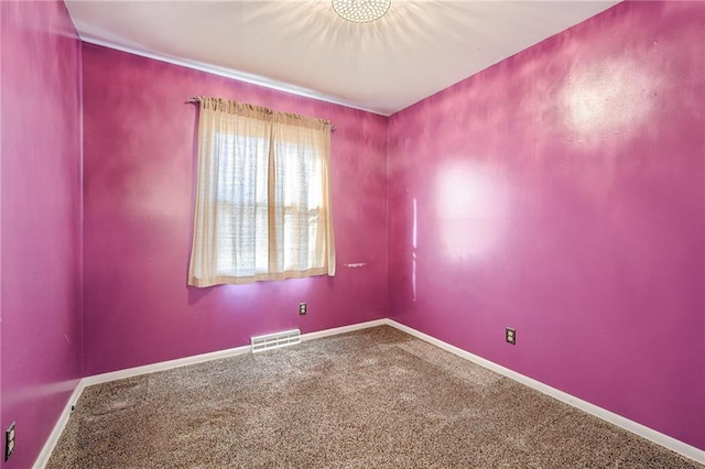 empty room with visible vents, carpet flooring, and baseboards