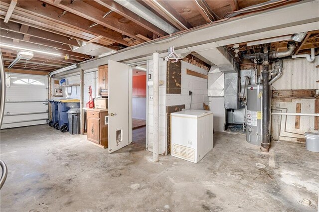 unfinished basement with water heater and fridge